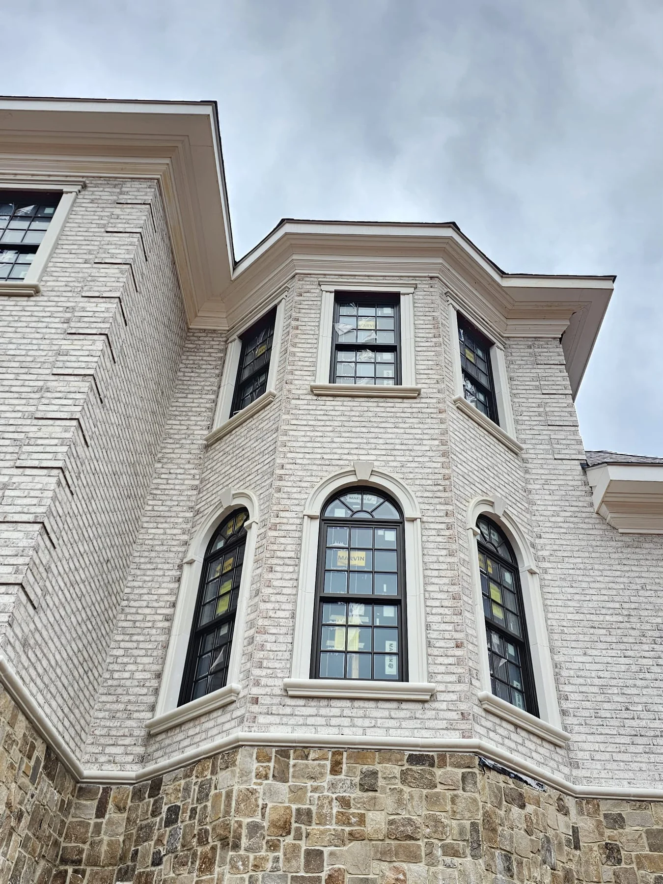 Detailed brickwork and custom windows on a luxury residence